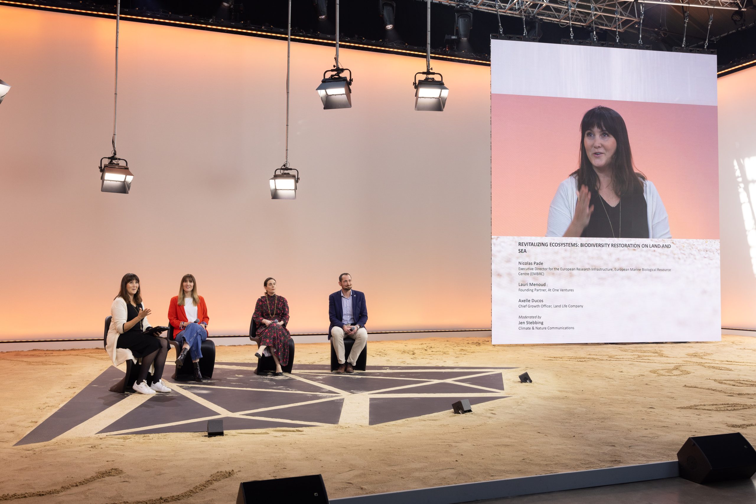 A panel of four seated speakers on the main stage at the Hello Tomorrow Global Summit in Paris