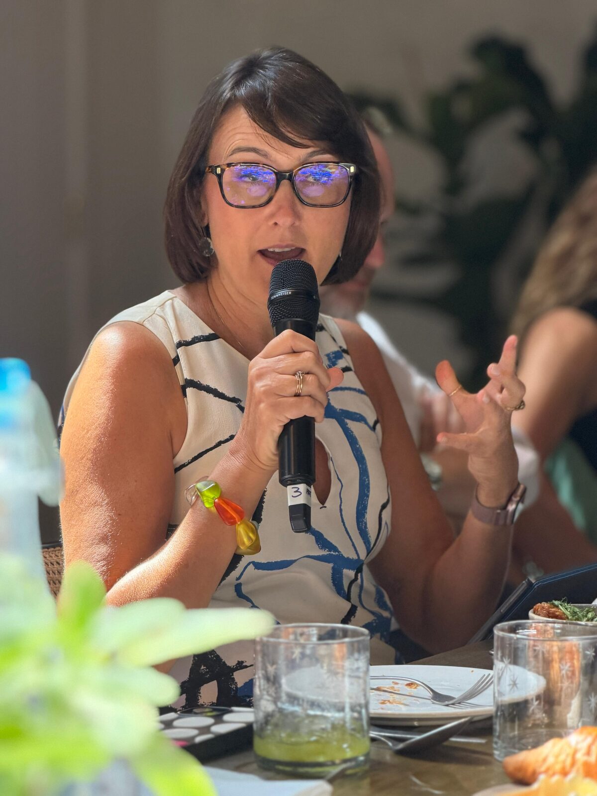 Jen Stebbing speaking into a microphone at a round table during London Climate Action Week