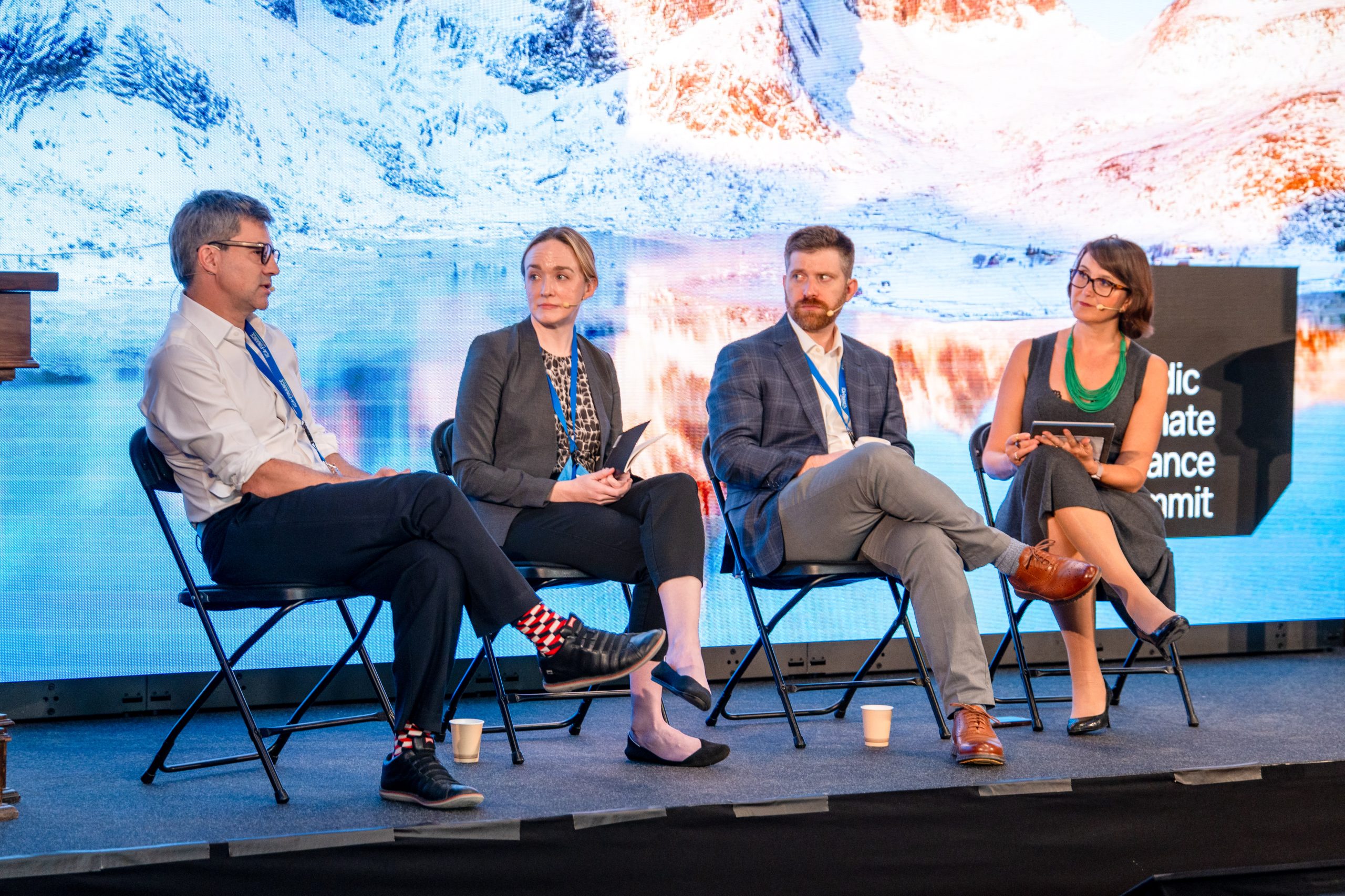 A four-person panel in conversation on stage at the Nordic Climate Finance Summit, Oslo
